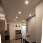 Modern kitchen with dining table and chairs.