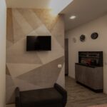 Modern living room with abstract wall design.