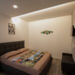 Modern bedroom with decorative wall art.