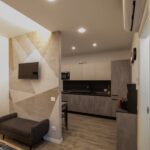 Modern studio apartment with kitchen and sofa.