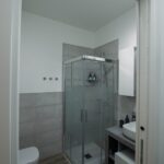 Modern bathroom with glass shower enclosure.