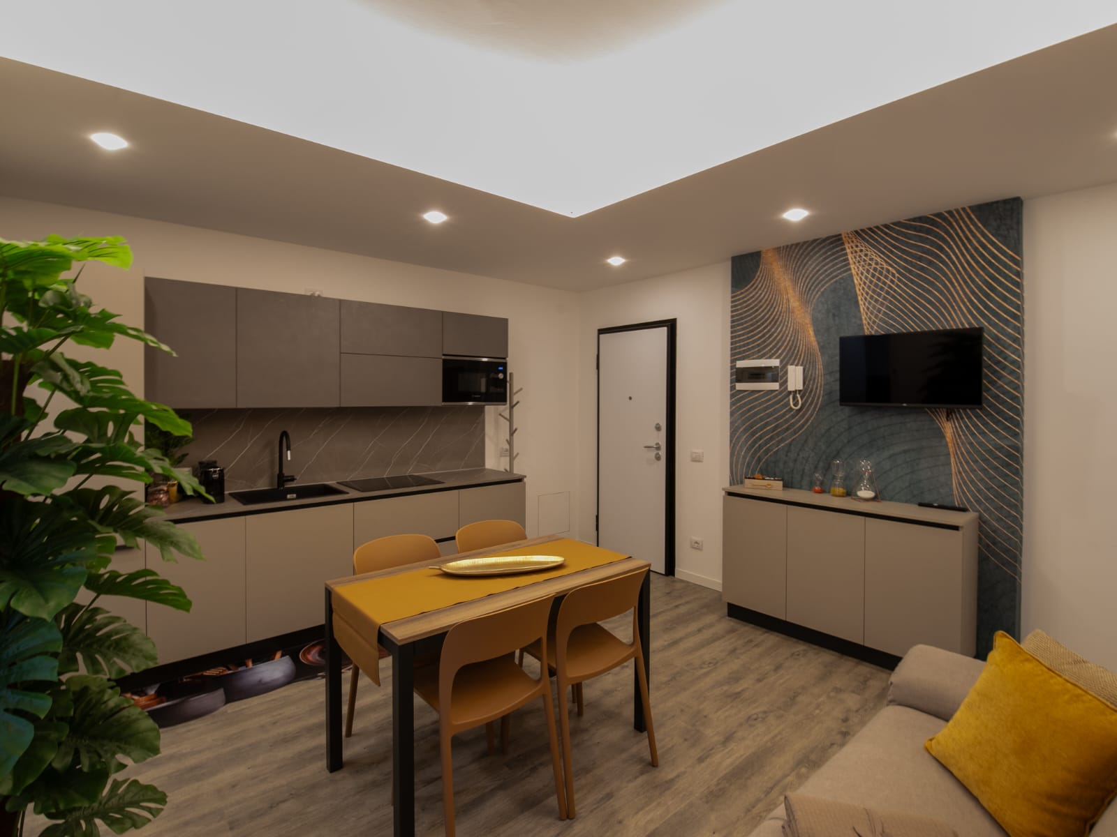 Modern kitchen and dining area with decor.