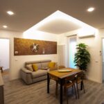 Modern living room with dining table setup.