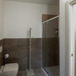 Modern bathroom with shower and toilet.