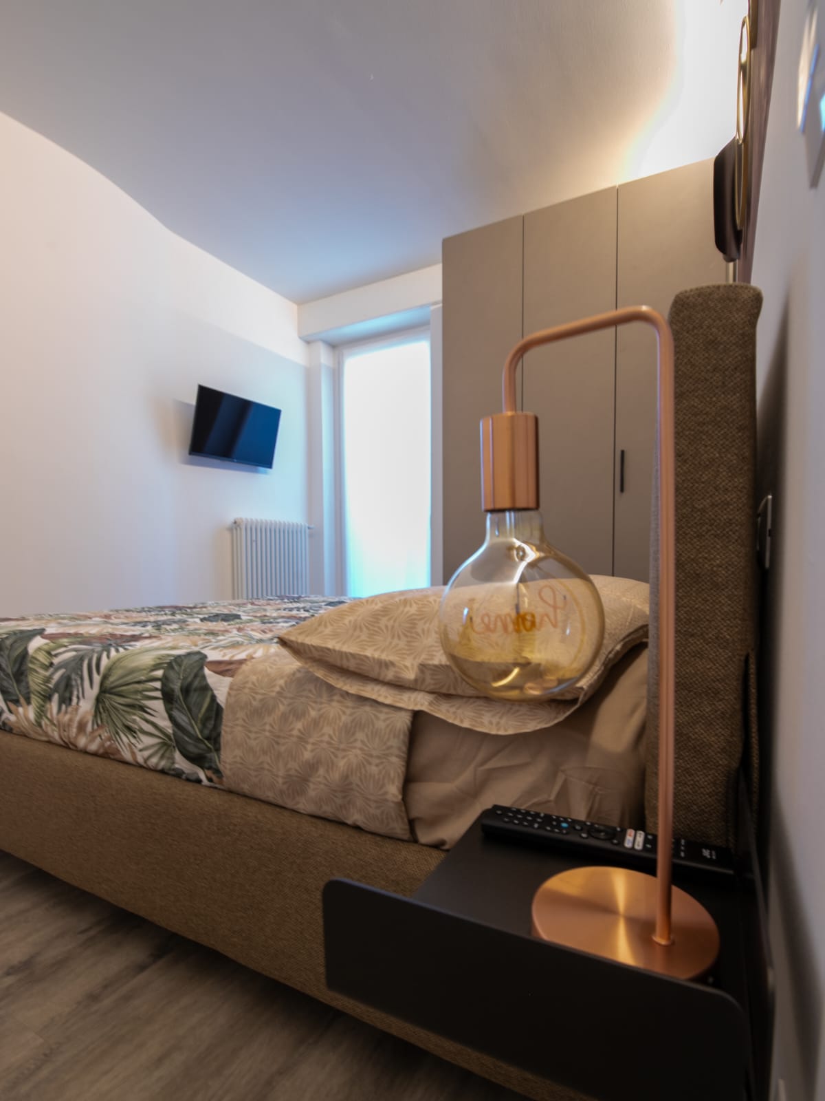 Modern bedroom with elegant lighting and decor.