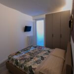 Small cozy bedroom with patterned bedspread.