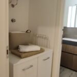 Small laundry area with cabinet and heater.