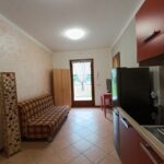 Small modern kitchen and living area interior.