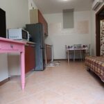 Small kitchen with table and appliances.