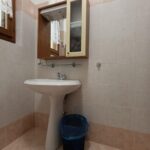 Bathroom sink with mirror cabinet above.
