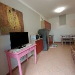 Small kitchen with table and television.