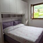 Cozy bedroom with open window and view.