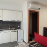 Modern kitchen and living area with sofa.