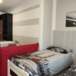 Twin beds in a modern furnished room.