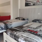 Two beds with Eiffel Tower decor.