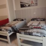 Twin beds in a modern hotel room.