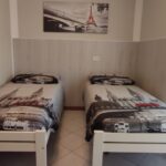 Two single beds in a bedroom.