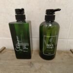 Green shampoo and body soap bottles displayed.