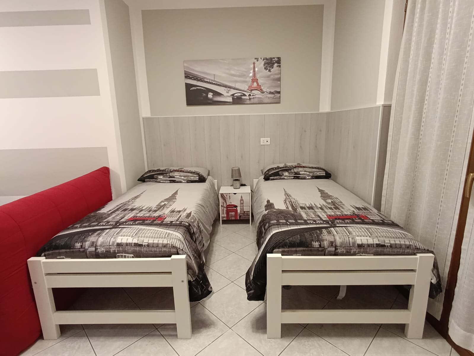 Twin beds with cityscape bedding and artwork.