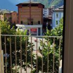 Balcony view of buildings and mountains.