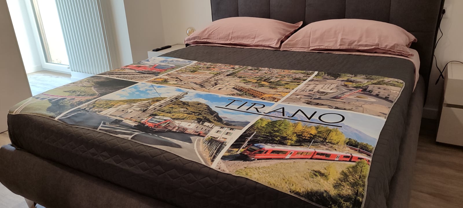 Bed with Tirano-themed blanket and pillows.