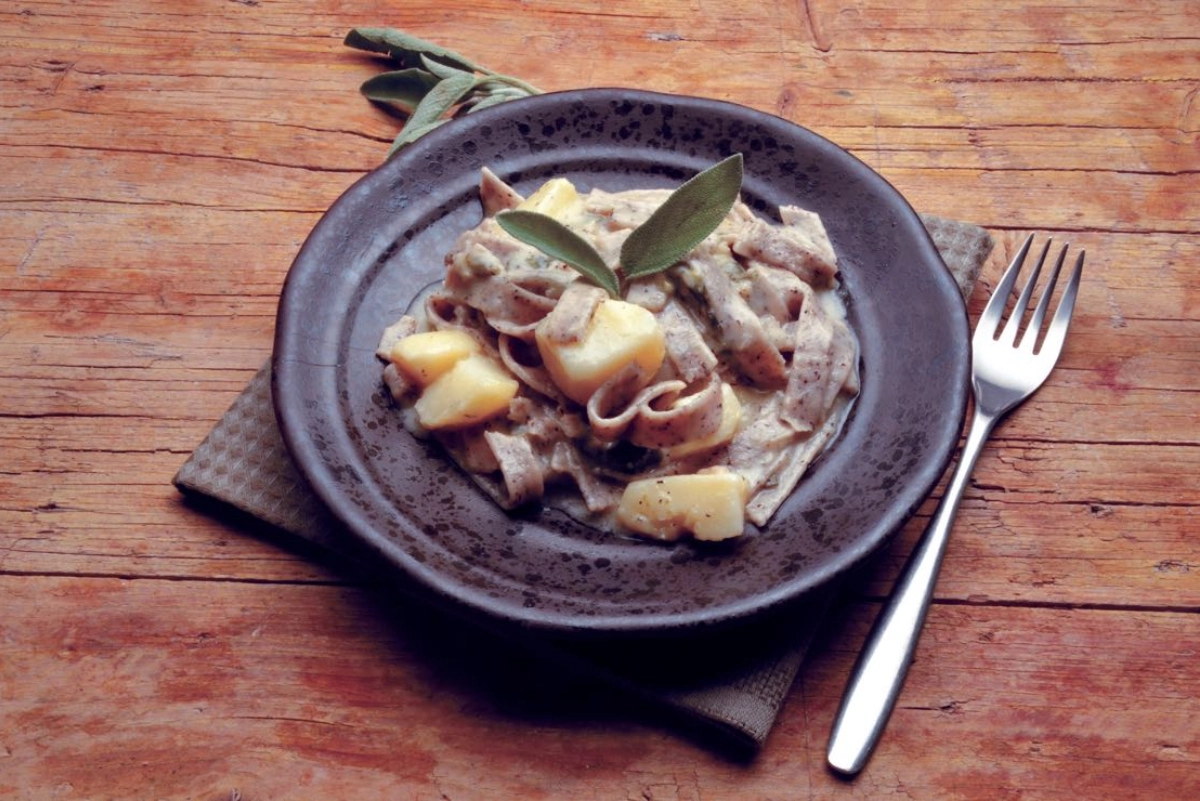 Pasta with creamy sauce and sage leaves.