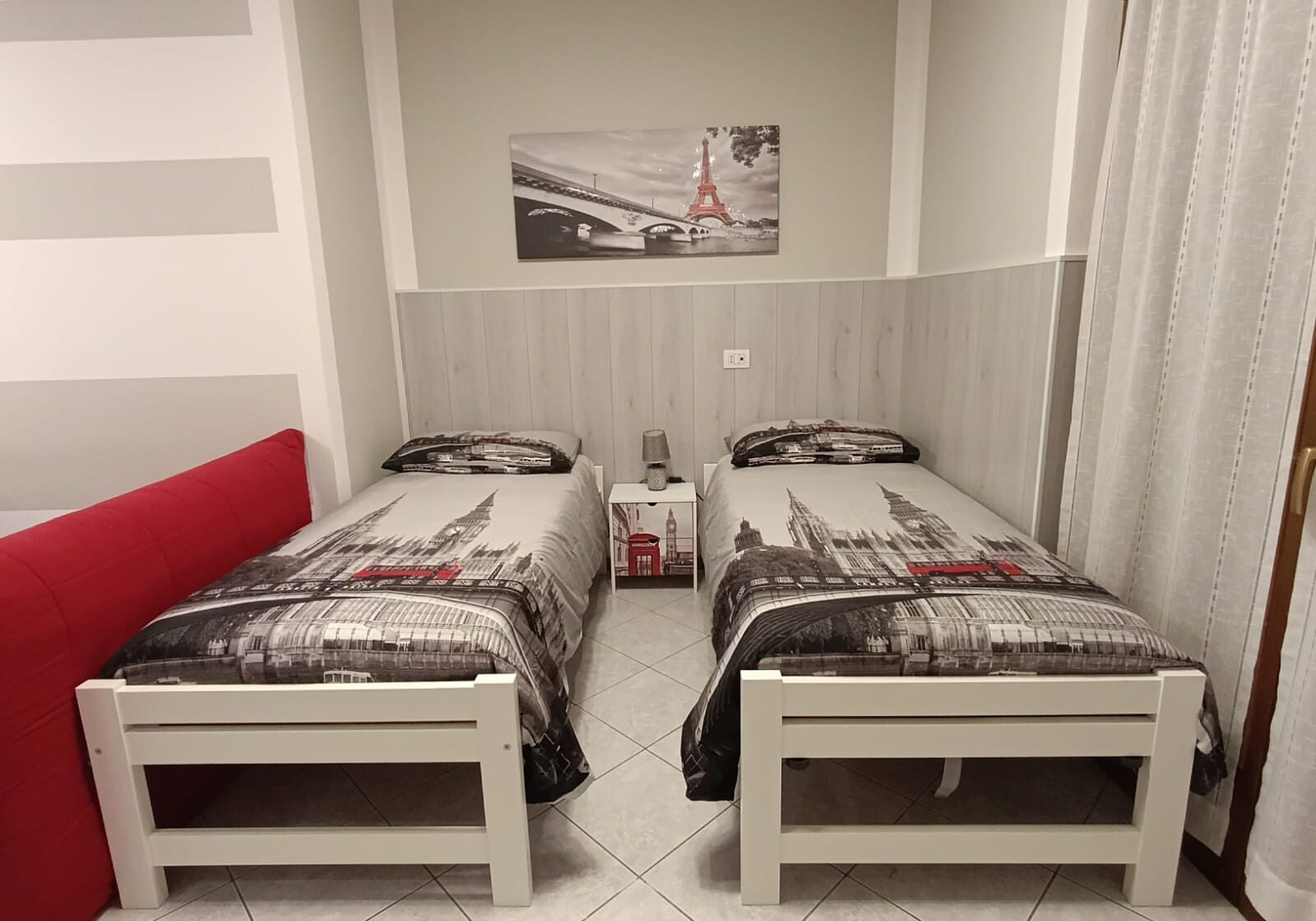 Twin beds with cityscape bedding and artwork.